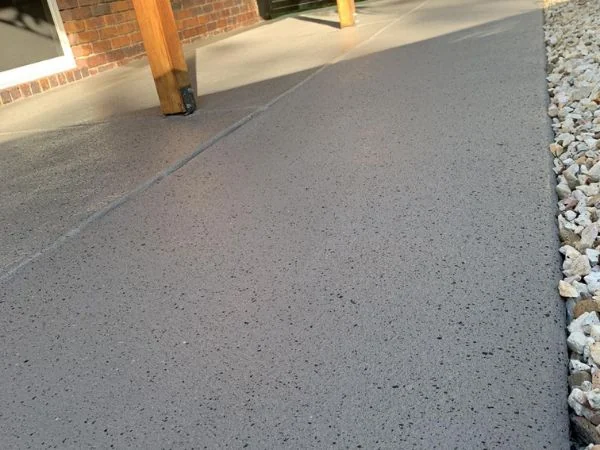 Completed honed and sealed exposed-aggregate concrete entrance