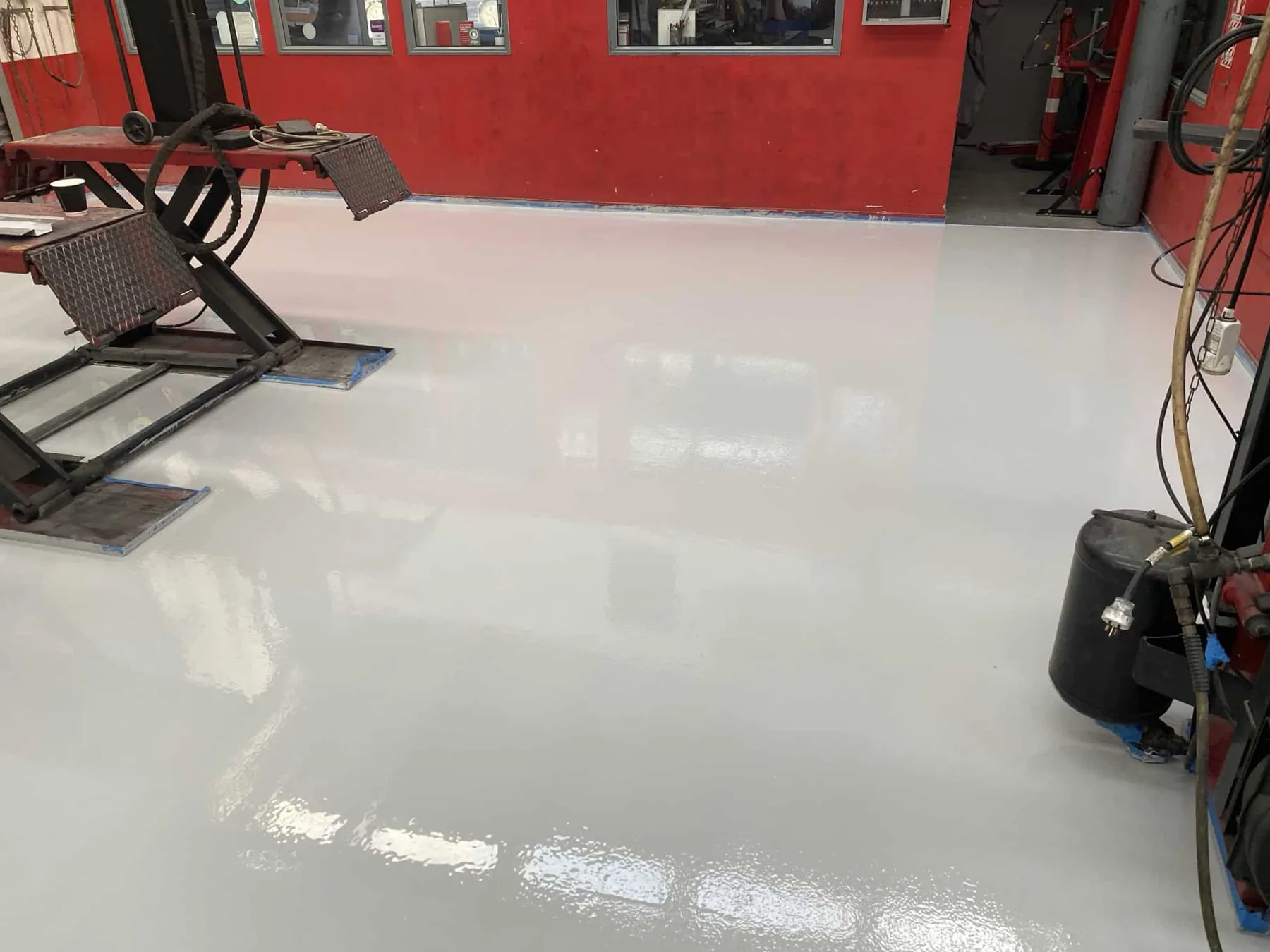 Freshly finished light-grey garage workshop floor coating